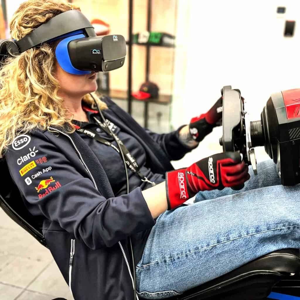 Brand activation for Exxonmobile - happy lady in a F1 seat and with virtual reality wearing F1 team tshirt.