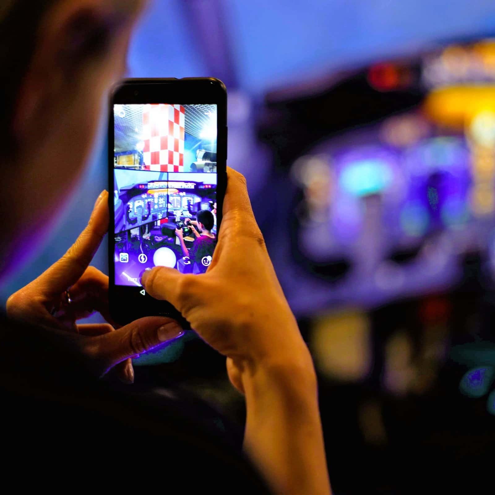 RoarFun Clients Technical Museum flight immersive simulator with motion taking a picture with Iphone